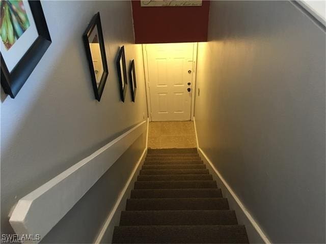 stairway featuring tile patterned floors