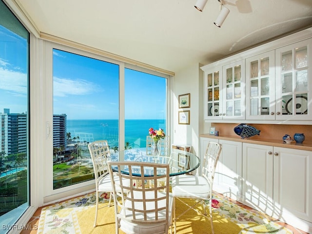 sunroom / solarium with a water view