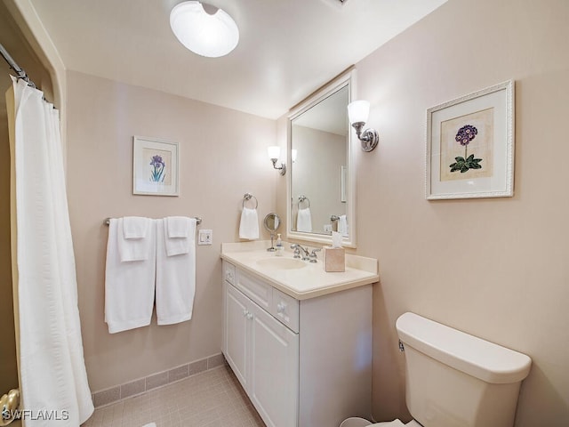 bathroom featuring tile patterned flooring, vanity, and toilet