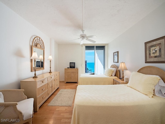 bedroom with ceiling fan and light wood-type flooring