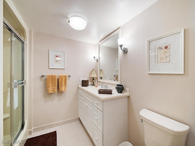 bathroom with vanity, toilet, and walk in shower