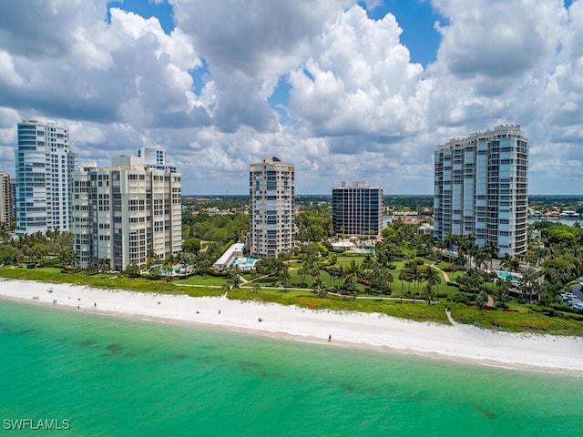 drone / aerial view featuring a view of the beach and a water view