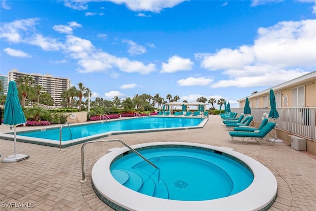 view of pool with a patio area and a community hot tub