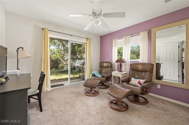 sitting room with light carpet, plenty of natural light, and ceiling fan