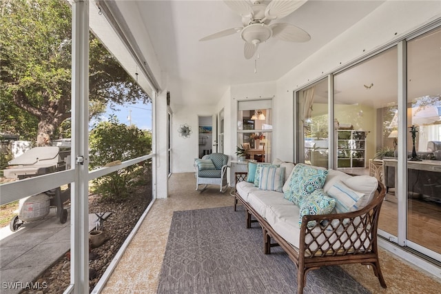 sunroom / solarium featuring ceiling fan