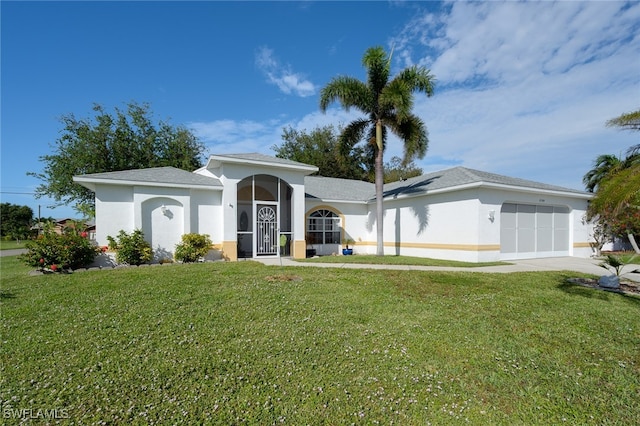 ranch-style home featuring a front lawn and a garage