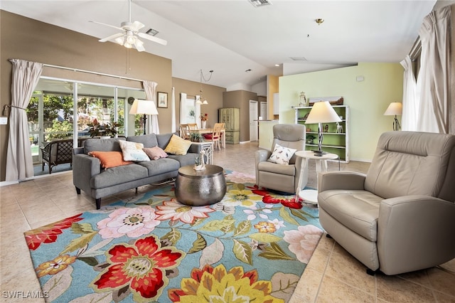 living room featuring ceiling fan, lofted ceiling, and light tile patterned flooring