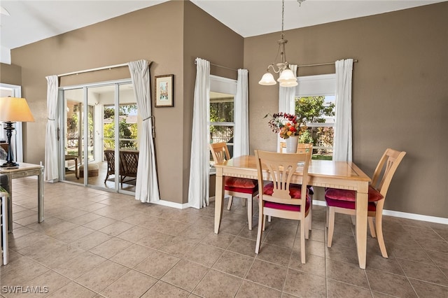 tiled dining room with a wealth of natural light and a chandelier