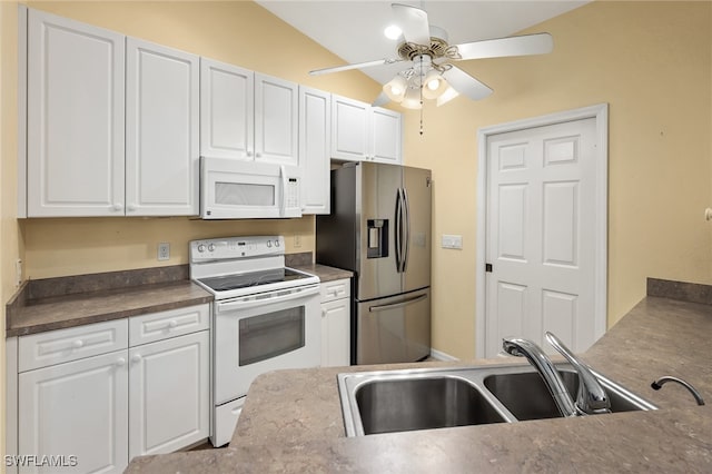 kitchen featuring white cabinetry, white appliances, sink, and vaulted ceiling