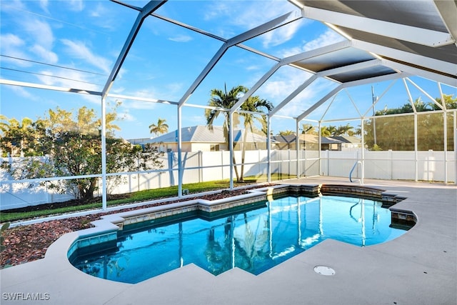 view of swimming pool featuring a patio and a lanai