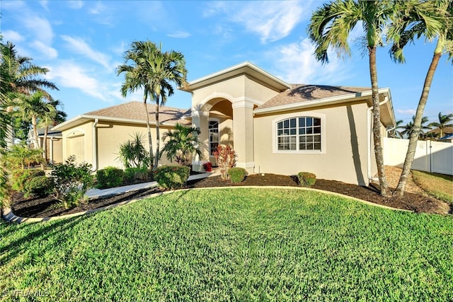 mediterranean / spanish home with a garage and a front lawn