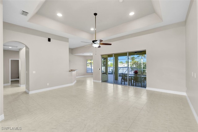 unfurnished room featuring a tray ceiling and ceiling fan