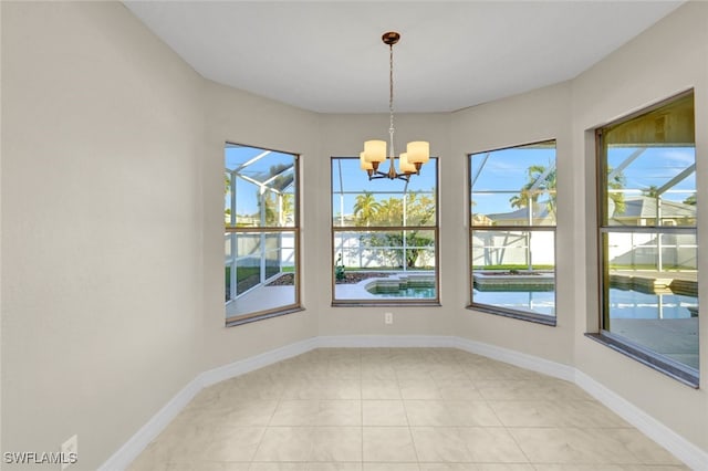 unfurnished dining area featuring a wealth of natural light, light tile patterned floors, and a chandelier