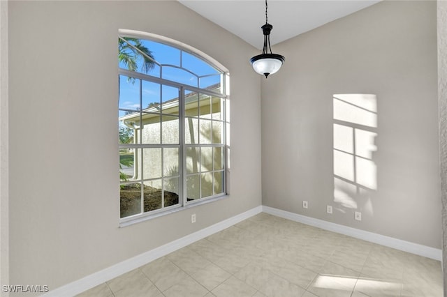 spare room featuring light tile patterned flooring