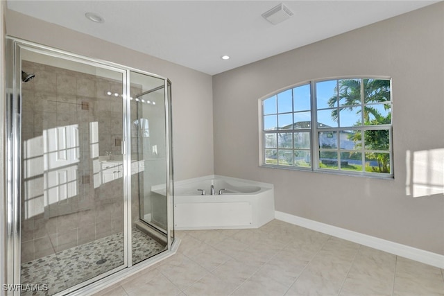 bathroom with tile patterned flooring and separate shower and tub