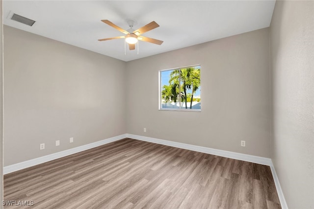 spare room with ceiling fan and light hardwood / wood-style flooring