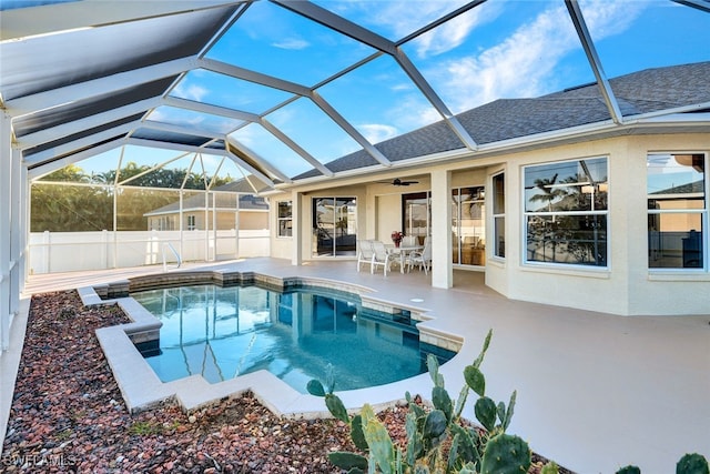 view of swimming pool with a lanai, ceiling fan, and a patio