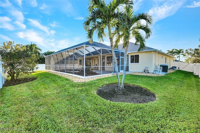 rear view of house featuring a yard and a lanai