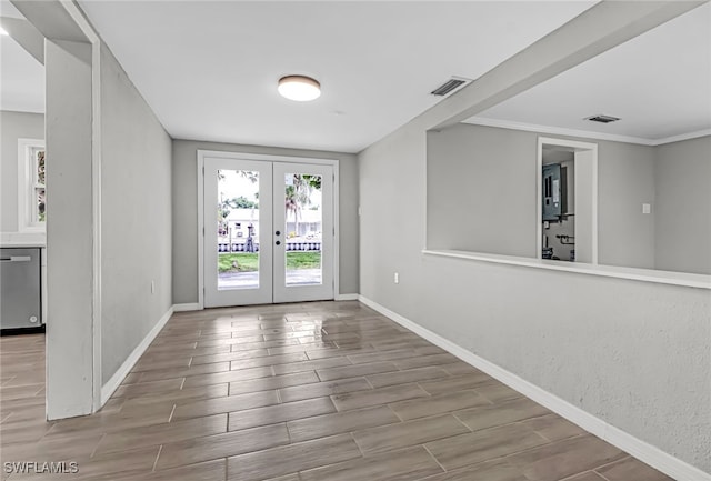 entryway with french doors, ornamental molding, and hardwood / wood-style floors