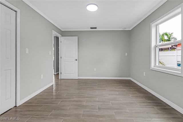 unfurnished bedroom featuring light wood-type flooring and crown molding