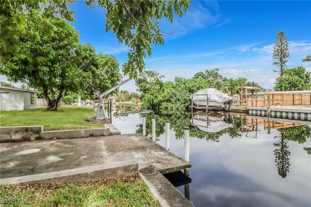 dock area with a yard and a water view