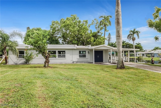 ranch-style house featuring a carport and a front lawn