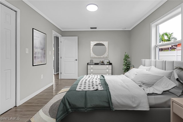 bedroom featuring dark hardwood / wood-style flooring and ornamental molding