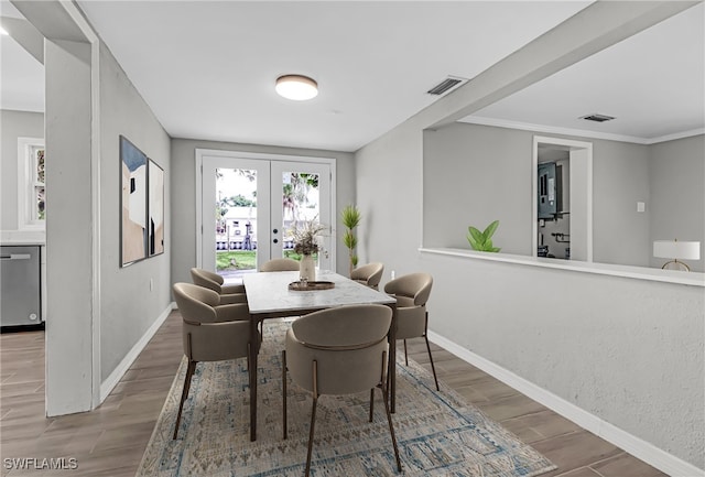 dining room featuring crown molding, french doors, and hardwood / wood-style flooring