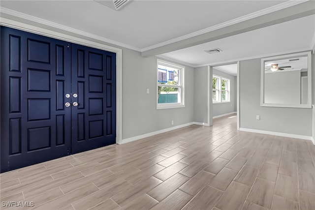 entrance foyer with ceiling fan, light hardwood / wood-style floors, and crown molding