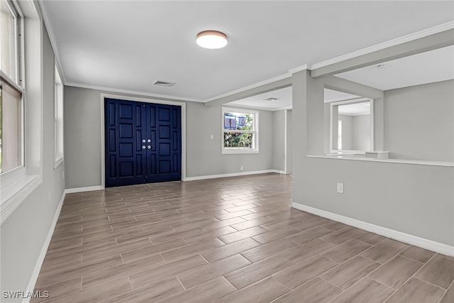 entrance foyer featuring light hardwood / wood-style flooring and crown molding