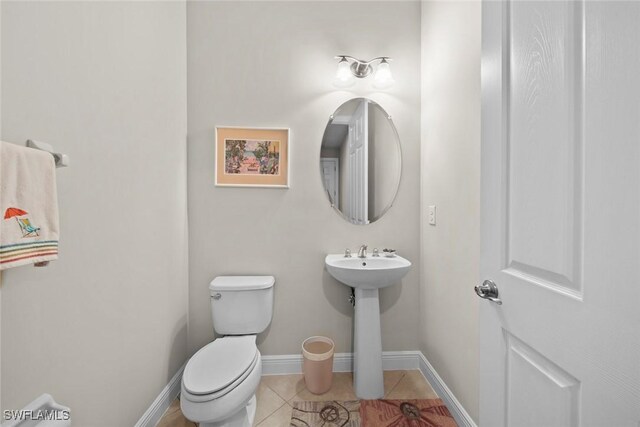 bathroom with tile patterned floors, sink, and toilet