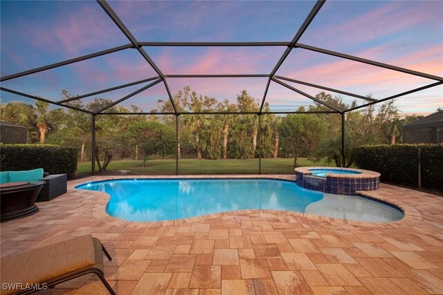 pool at dusk with a lanai and a patio