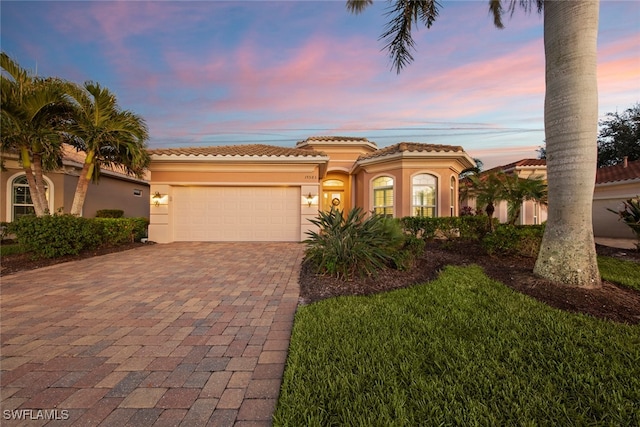 mediterranean / spanish-style home featuring a garage