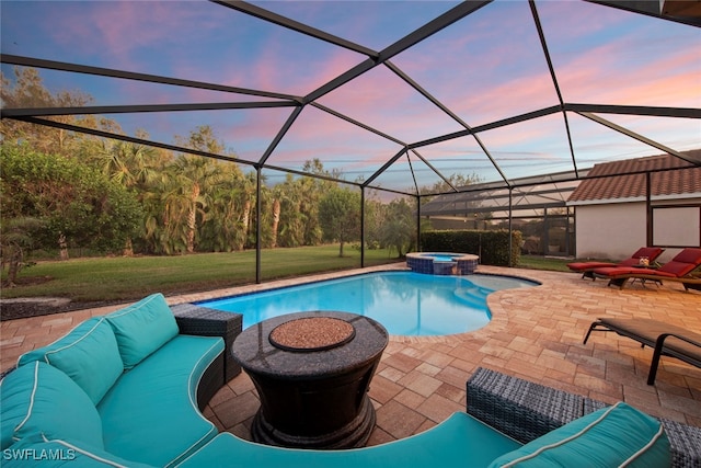 pool at dusk featuring a lawn, glass enclosure, outdoor lounge area, and a patio