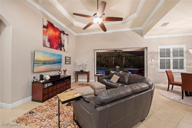 tiled living room featuring ceiling fan, a raised ceiling, and crown molding