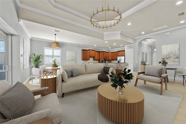 living room with light tile patterned flooring, ornamental molding, and a tray ceiling