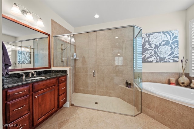 bathroom with tile patterned flooring, shower with separate bathtub, and vanity