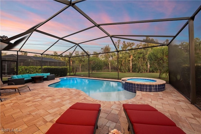 pool at dusk featuring a lanai, an outdoor hangout area, and a patio