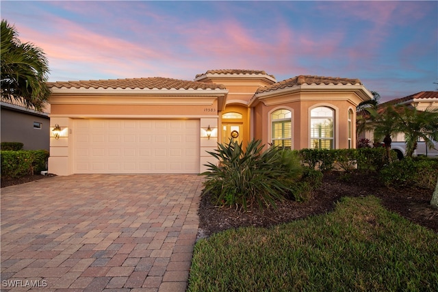 mediterranean / spanish-style house featuring a garage