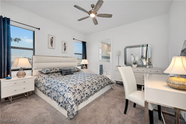 bedroom featuring ensuite bath, ceiling fan, and light colored carpet