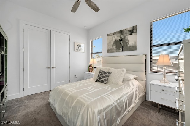 bedroom featuring ceiling fan, a closet, and dark colored carpet