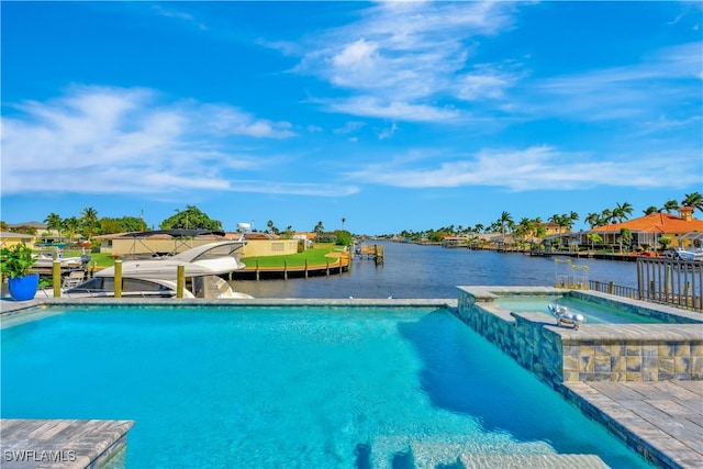 view of swimming pool with an in ground hot tub and a water view