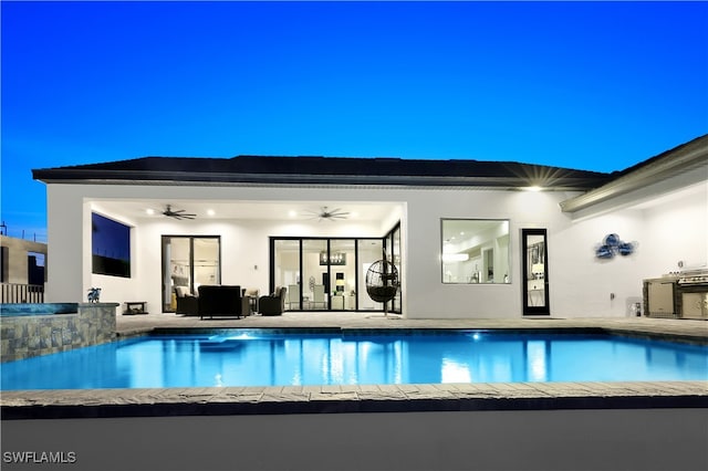 view of swimming pool featuring a patio and ceiling fan