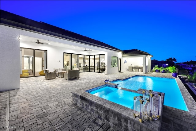 view of swimming pool with outdoor lounge area, ceiling fan, a patio area, and exterior kitchen