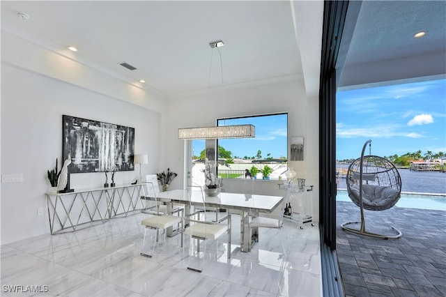 dining room featuring a water view