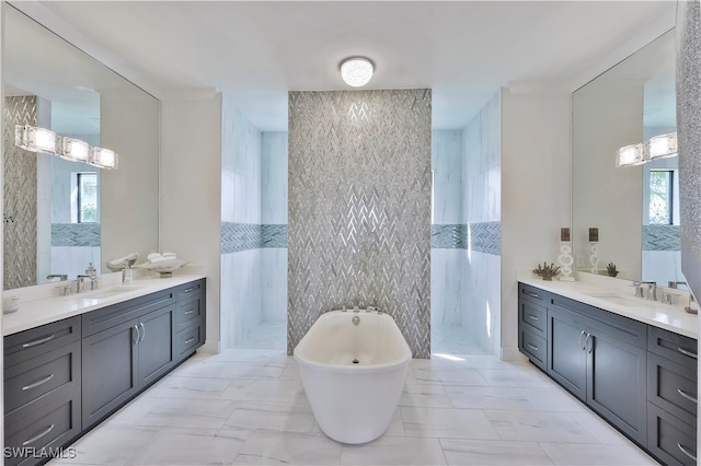 bathroom with vanity, tile walls, and a bathing tub