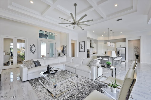 living room with beam ceiling, ceiling fan, french doors, and coffered ceiling