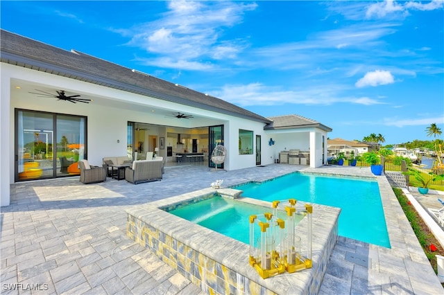 view of swimming pool featuring outdoor lounge area, an outdoor kitchen, ceiling fan, an in ground hot tub, and a patio