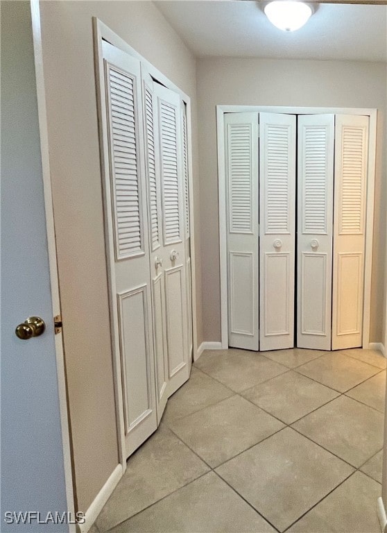 hall with light tile patterned floors