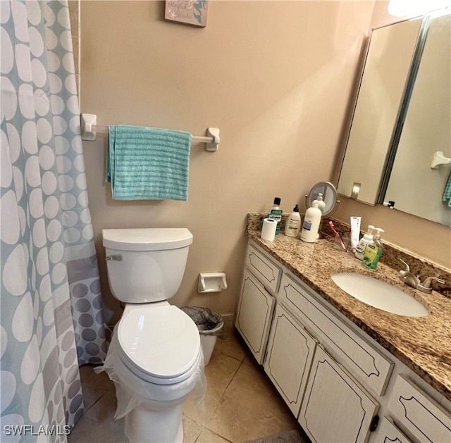 bathroom with tile patterned floors, vanity, and toilet